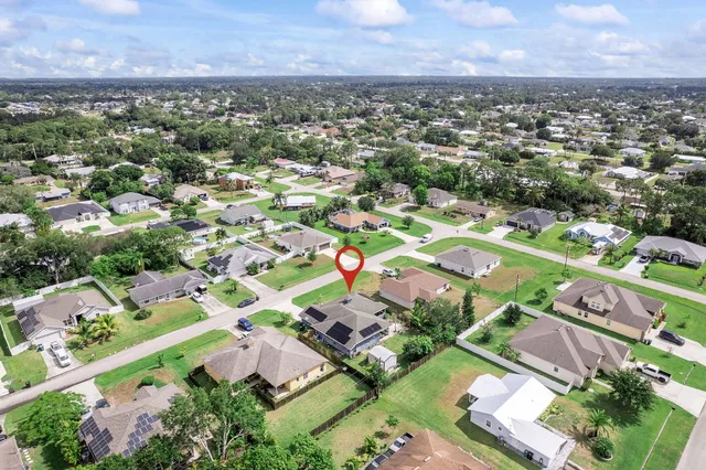 an aerial view of residential houses with outdoor space and street view