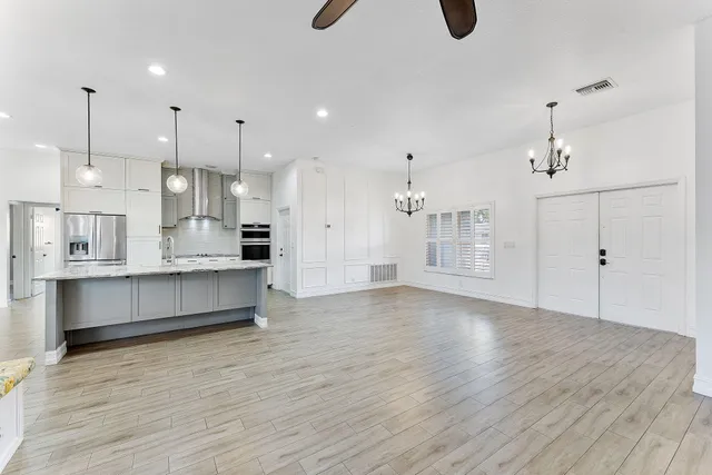 a view of kitchen and kitchen with stainless steel appliances