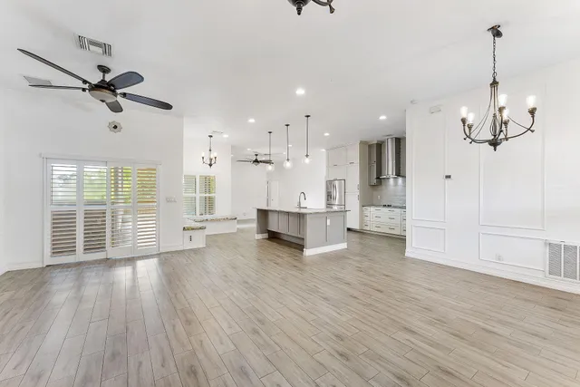 a view of a living room a kitchen and a wooden floor