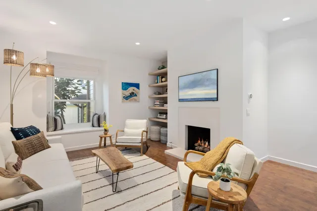 a living room with furniture fireplace and window