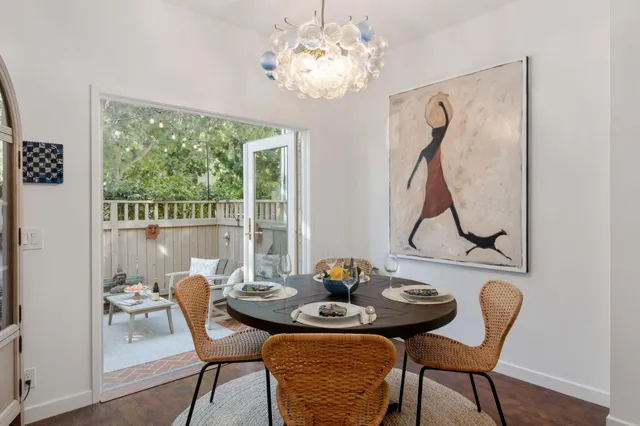 a balcony with wooden floor and outdoor seating