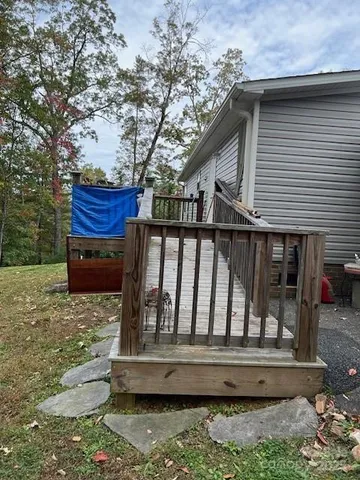 a view of wooden house with a yard