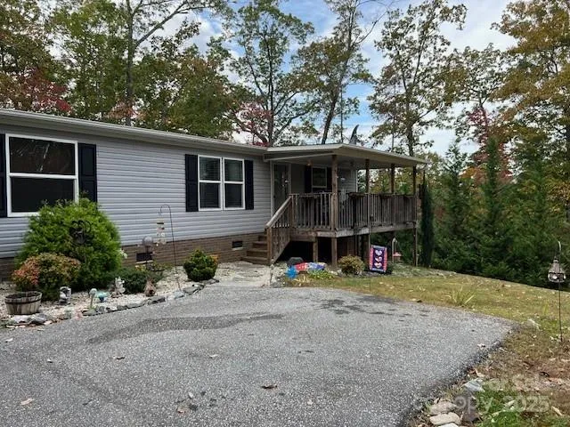 a view of a house with a yard and sitting area