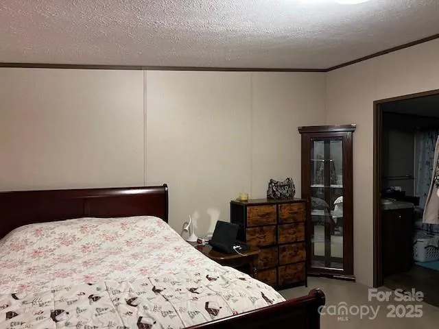 a bedroom with a bed and a dresser in it