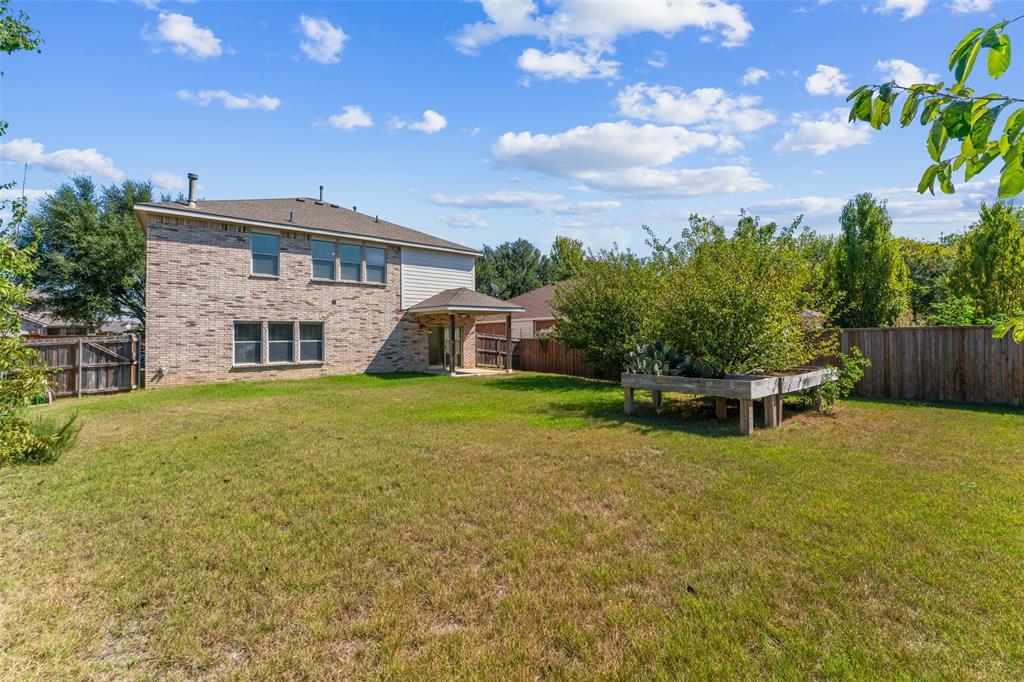 5891 Candlelight Lane Grand Prairie, TX 75052 - Photo 22 of 33 a front view of a house with garden