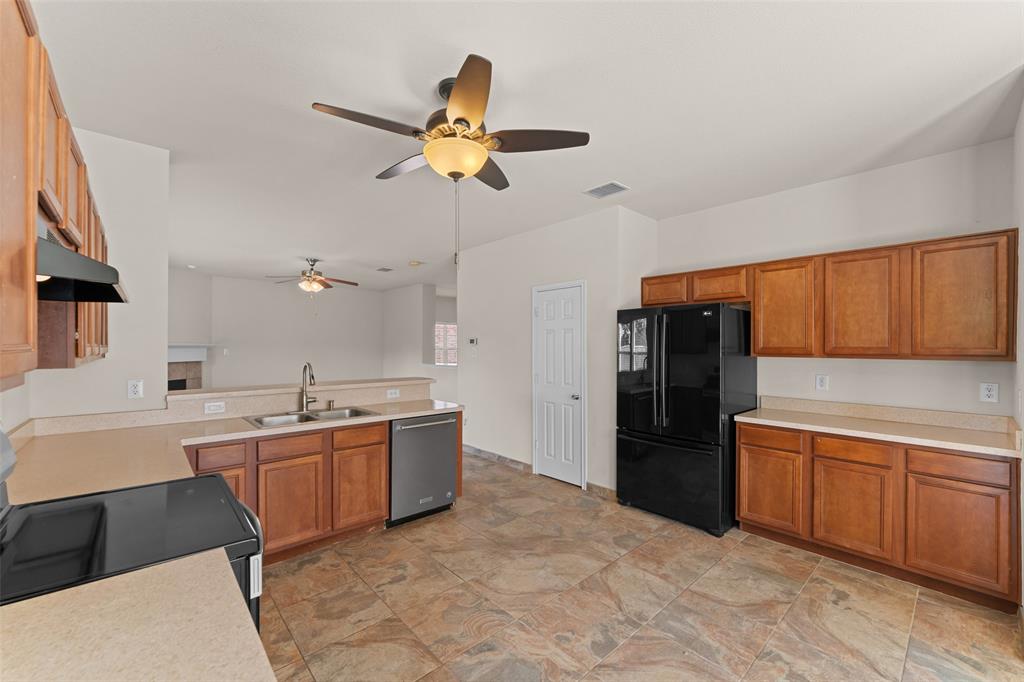 5891 Candlelight Lane Grand Prairie, TX 75052 - Photo 9 of 33 a kitchen with a sink stainless steel appliances and cabinets