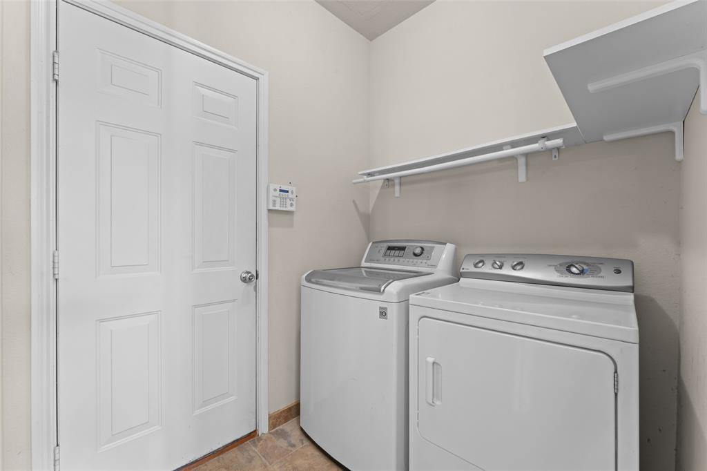 5891 Candlelight Lane Grand Prairie, TX 75052 - Photo 10 of 33 a view of storage and utility room with washer and dryer