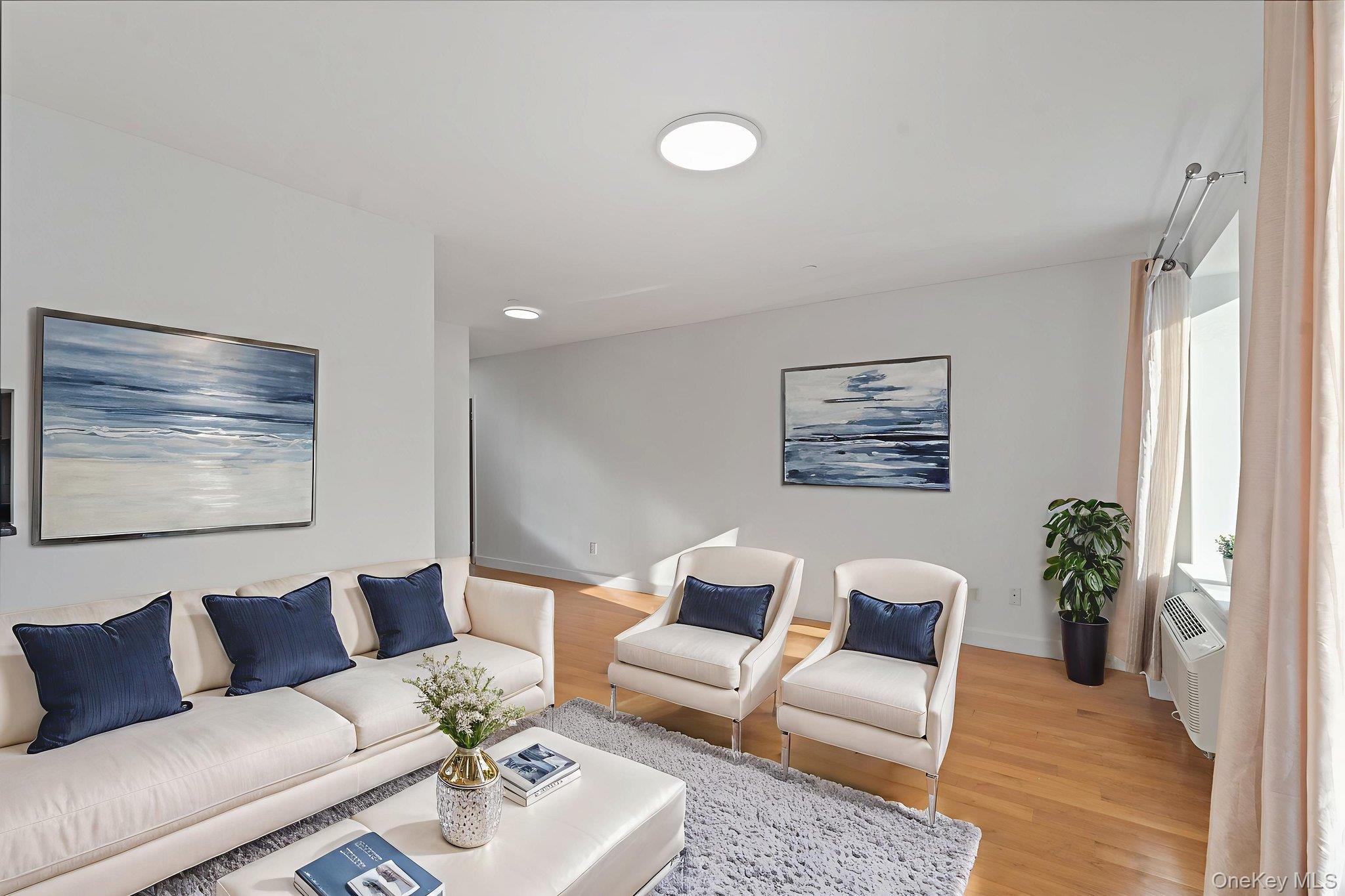 2360 Amsterdam Avenue, Unit 2C Manhattan, NY 10033 - Photo 14 of 29 Living area featuring light wood-style flooring and baseboards