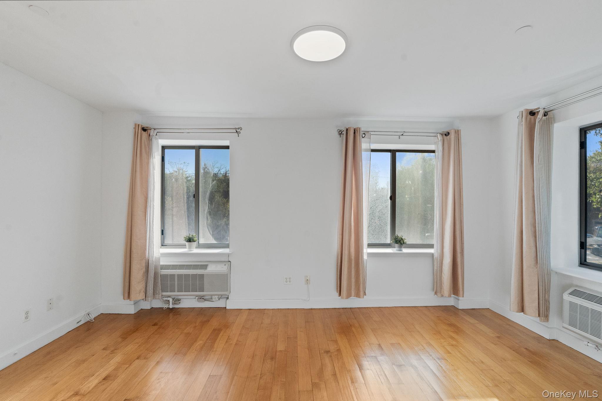 2360 Amsterdam Avenue, Unit 2C Manhattan, NY 10033 - Photo 16 of 29 Empty room featuring light wood-style flooring and baseboards