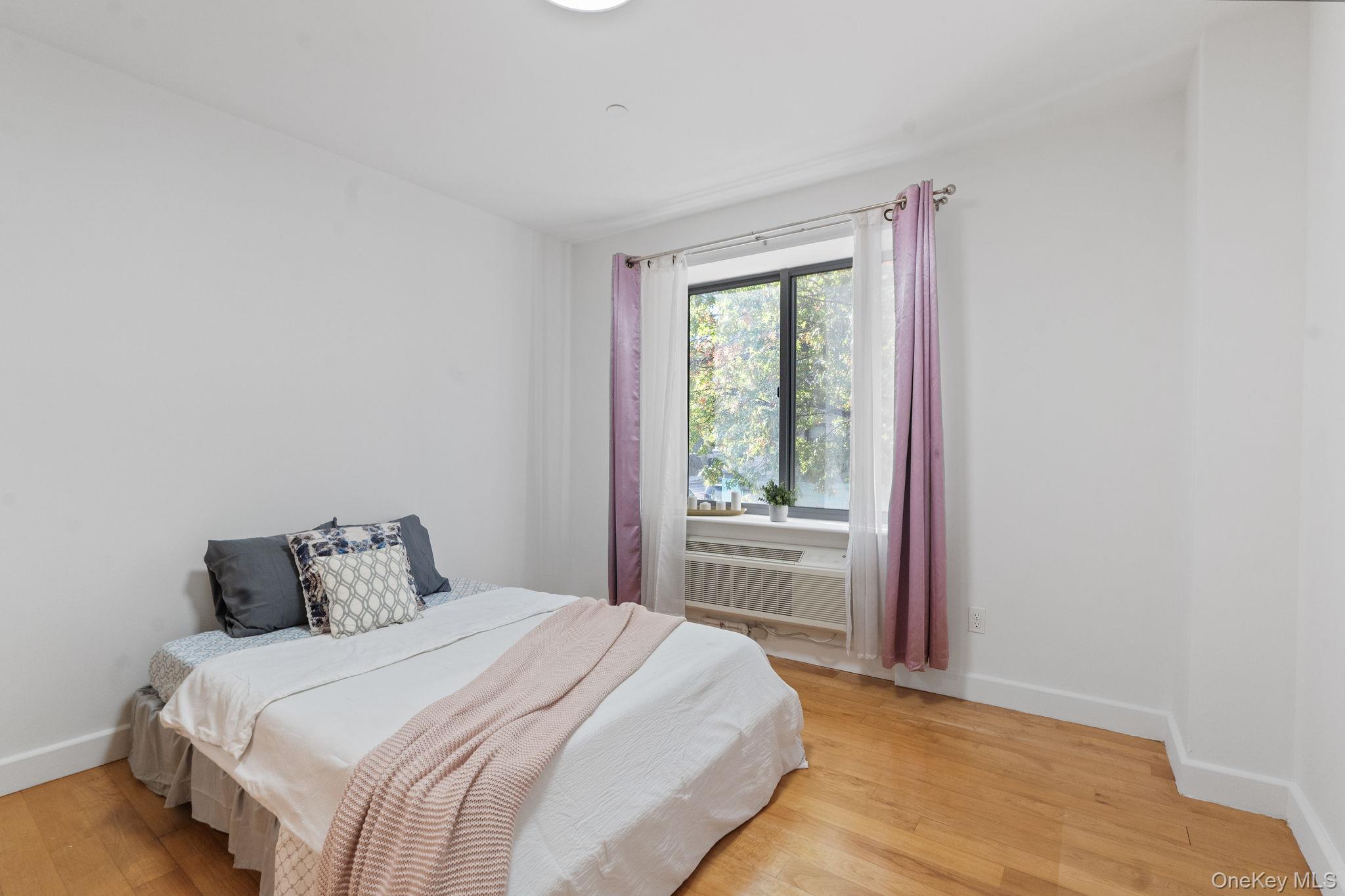 2360 Amsterdam Avenue, Unit 2C Manhattan, NY 10033 - Photo 4 of 29 Bedroom with light wood-style floors and radiator heating unit