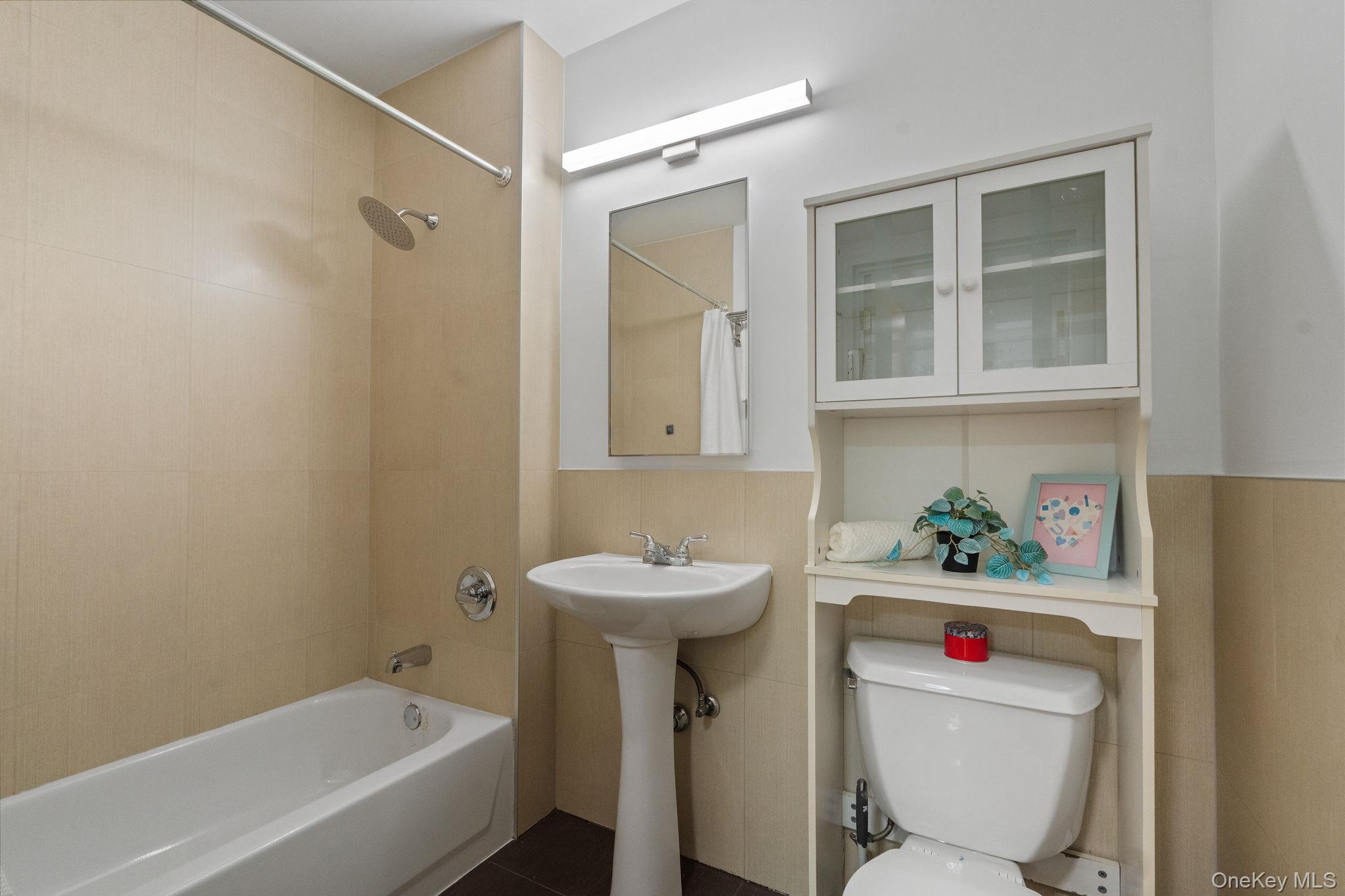 2360 Amsterdam Avenue, Unit 2C Manhattan, NY 10033 - Photo 6 of 29 Full bathroom featuring shower / bath combination with curtain and toilet