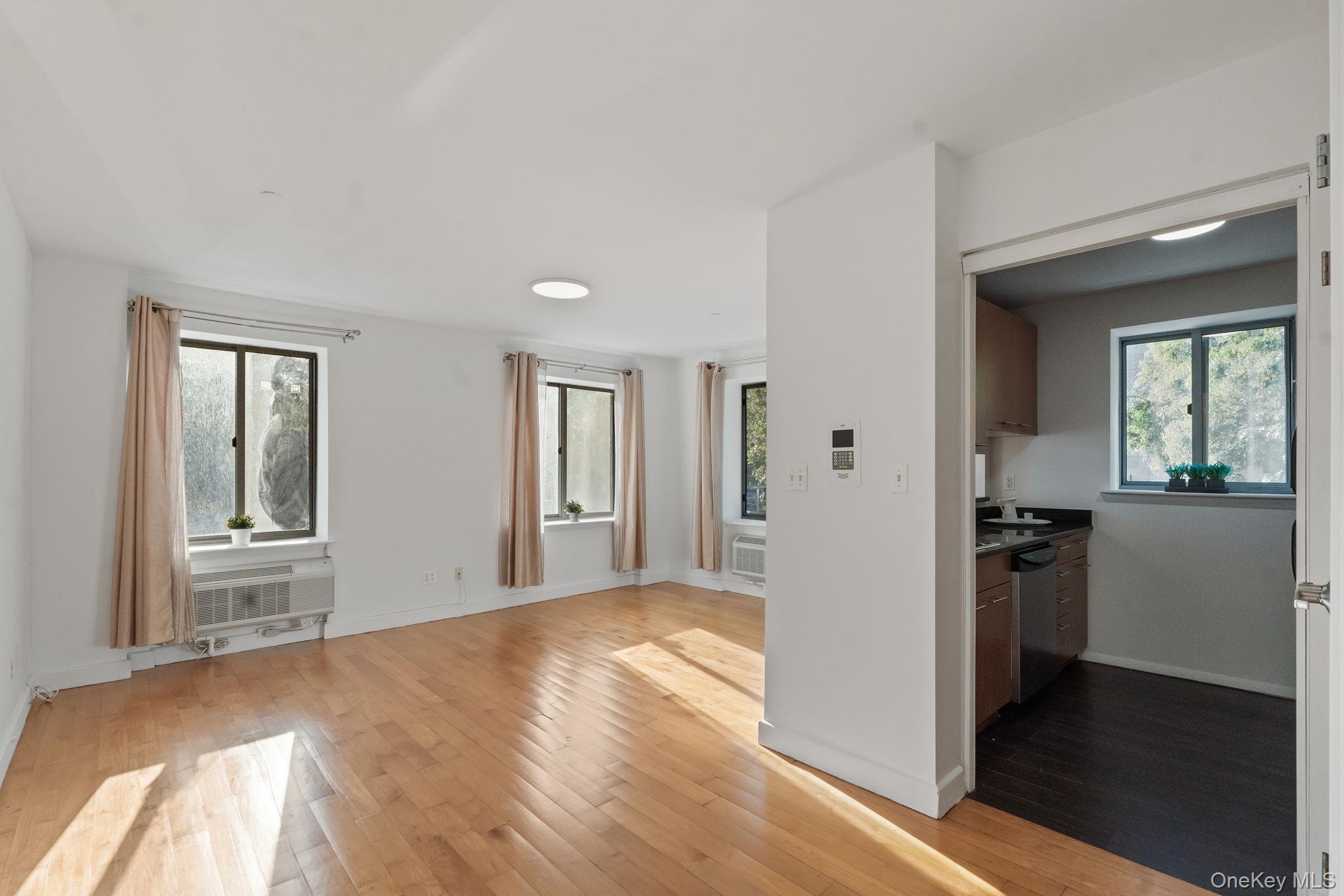 2360 Amsterdam Avenue, Unit 2C Manhattan, NY 10033 - Photo 10 of 29 Unfurnished living room with light wood-type flooring
