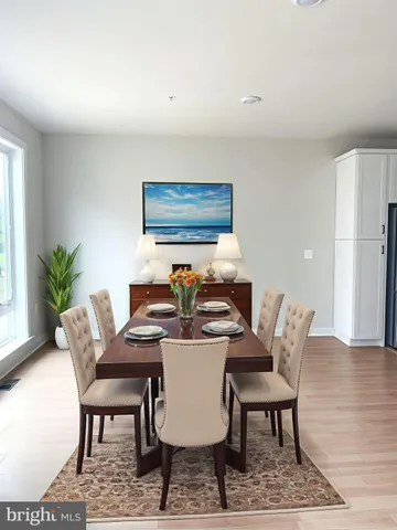 a view of a livingroom with wooden floor and window
