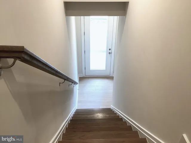 a kitchen with stainless steel appliances granite countertop a dining table chairs stove refrigerator and microwave