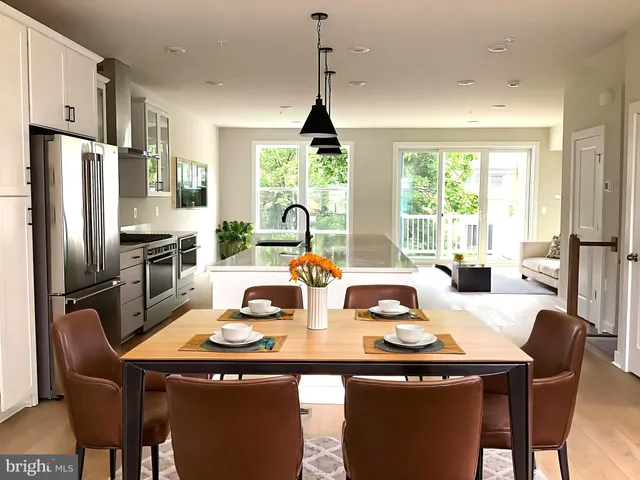 a kitchen with stainless steel appliances granite countertop a refrigerator a stove and a refrigerator