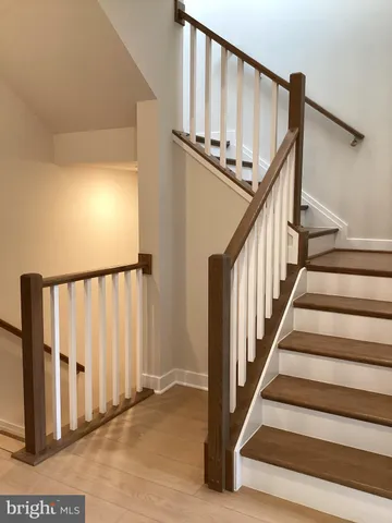 a view of a room with stairs and white walls
