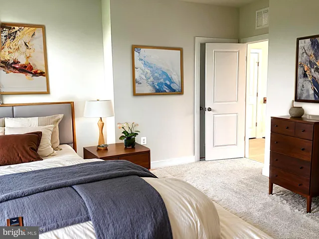 a bedroom with a large bed and a flat screen tv