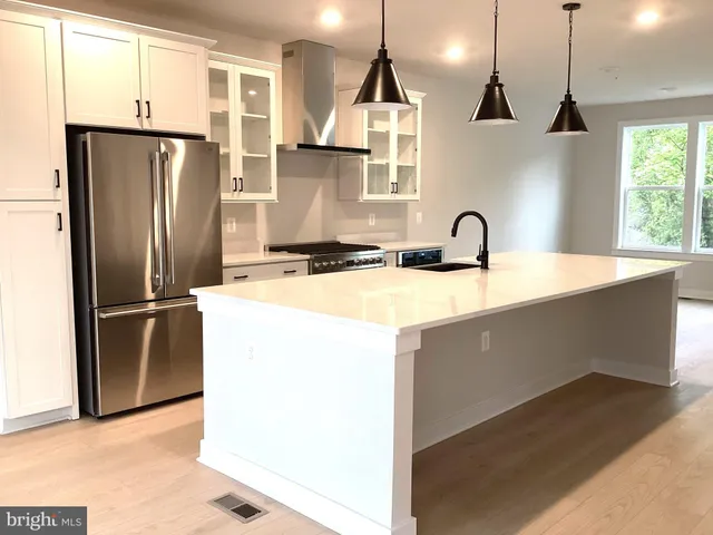 a kitchen with counter top space and living room