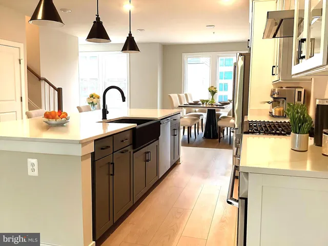 a kitchen with a table chairs stove and cabinets