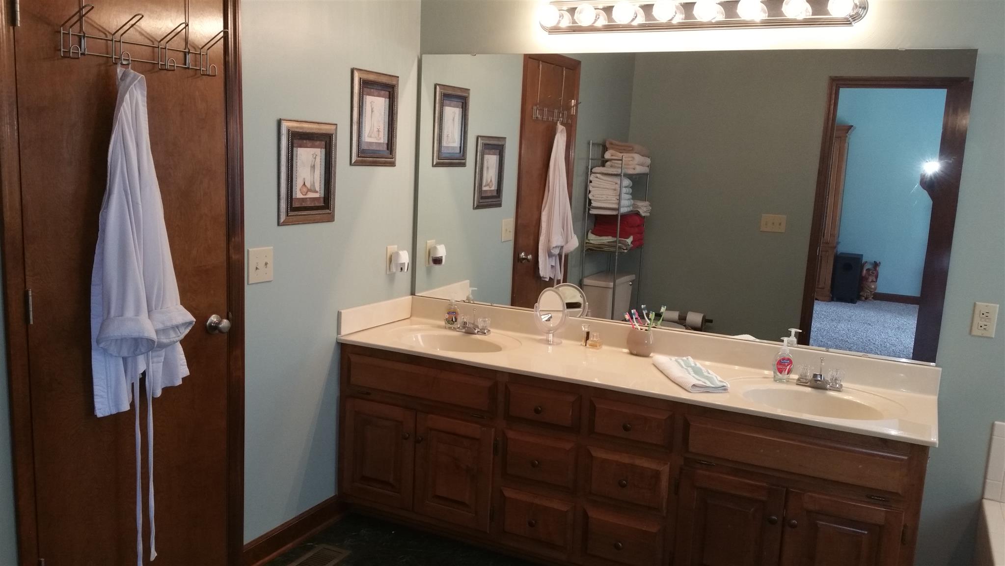 155 Knights Church Road Decherd, TN 37324 - Photo 11 of 29 a bathroom with a double vanity sink and a mirror