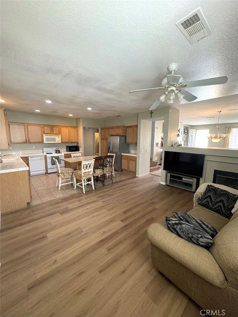 643 Canyon Crest Road Beaumont, CA 92223 - Photo 3 of 6 a living room with furniture and a fireplace