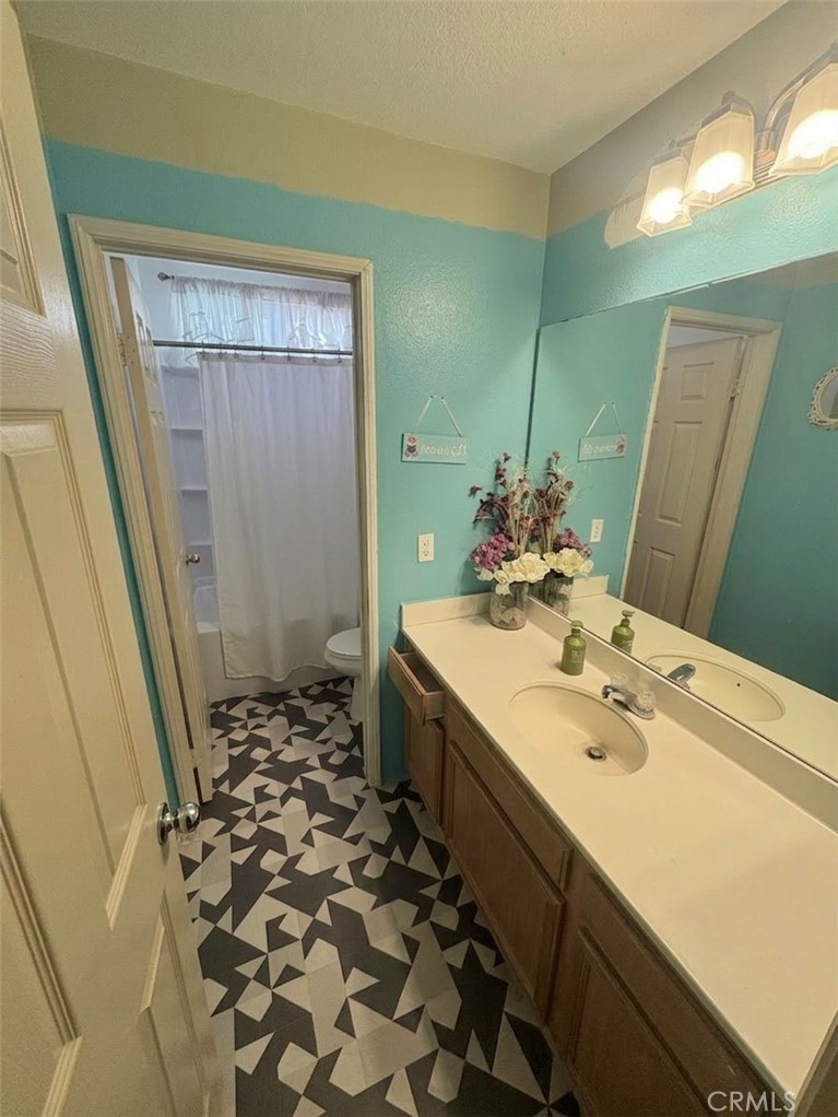 643 Canyon Crest Road Beaumont, CA 92223 - Photo 6 of 6 a bathroom with a sink and a mirror