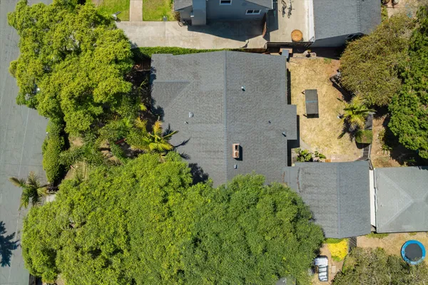 an aerial view of a house with a yard