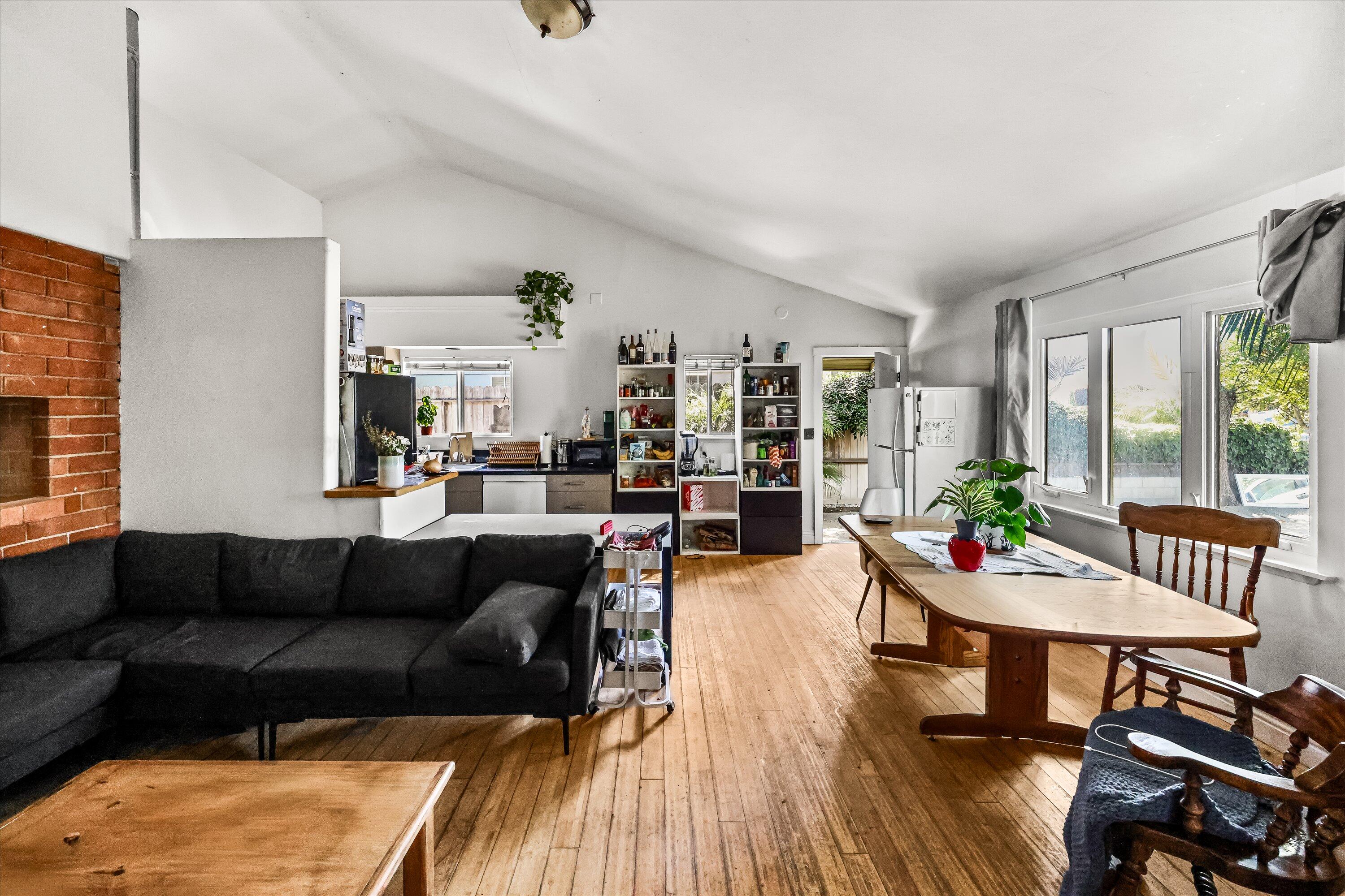 6880 Pasado Road Goleta, CA 93117 - Photo 4 of 15 a living room with furniture and a dining table with wooden floor