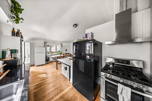 a kitchen with stainless steel appliances granite countertop a stove refrigerator and a microwave
