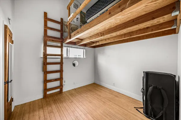 a view of a storage & utility room with wooden floor