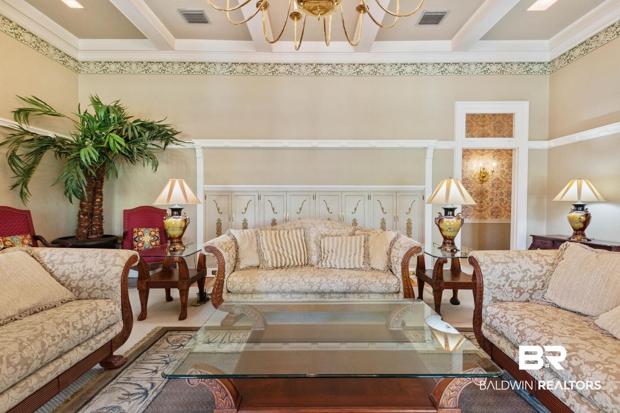 1701 Sowell Road Brewton, AL 36426 - Photo 20 of 83 Living room featuring suspended lighting, carpet, and crown molding
