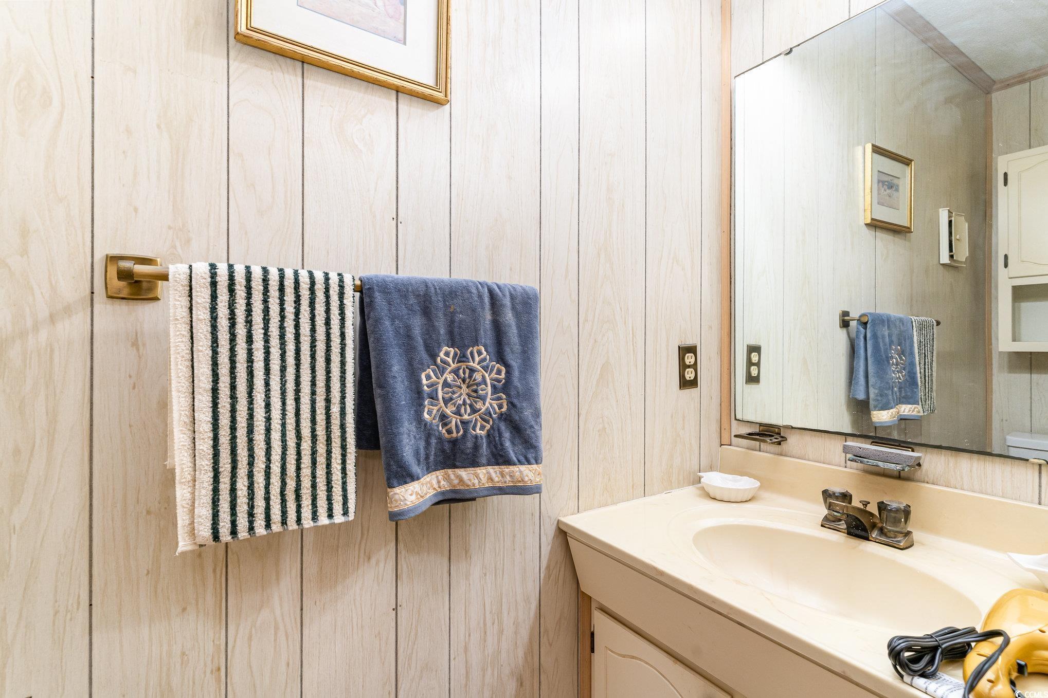 1582 South Waccamaw Drive, Unit 60 Murrells Inlet, SC 29576 - Photo 13 of 24 Bathroom with wood walls and vanity