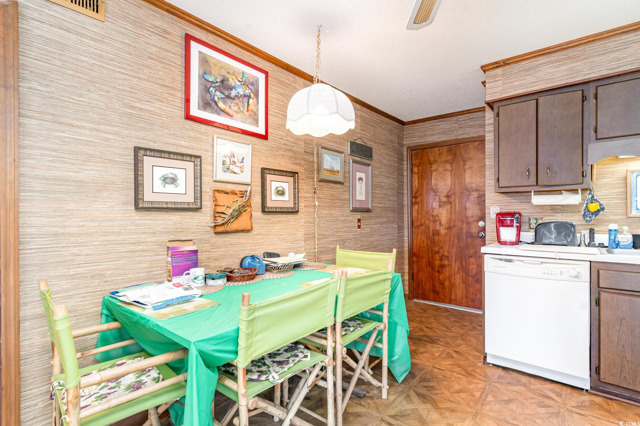 1582 South Waccamaw Drive, Unit 60 Murrells Inlet, SC 29576 - Photo 2 of 24 Dining space with ornamental molding and light parquet floors