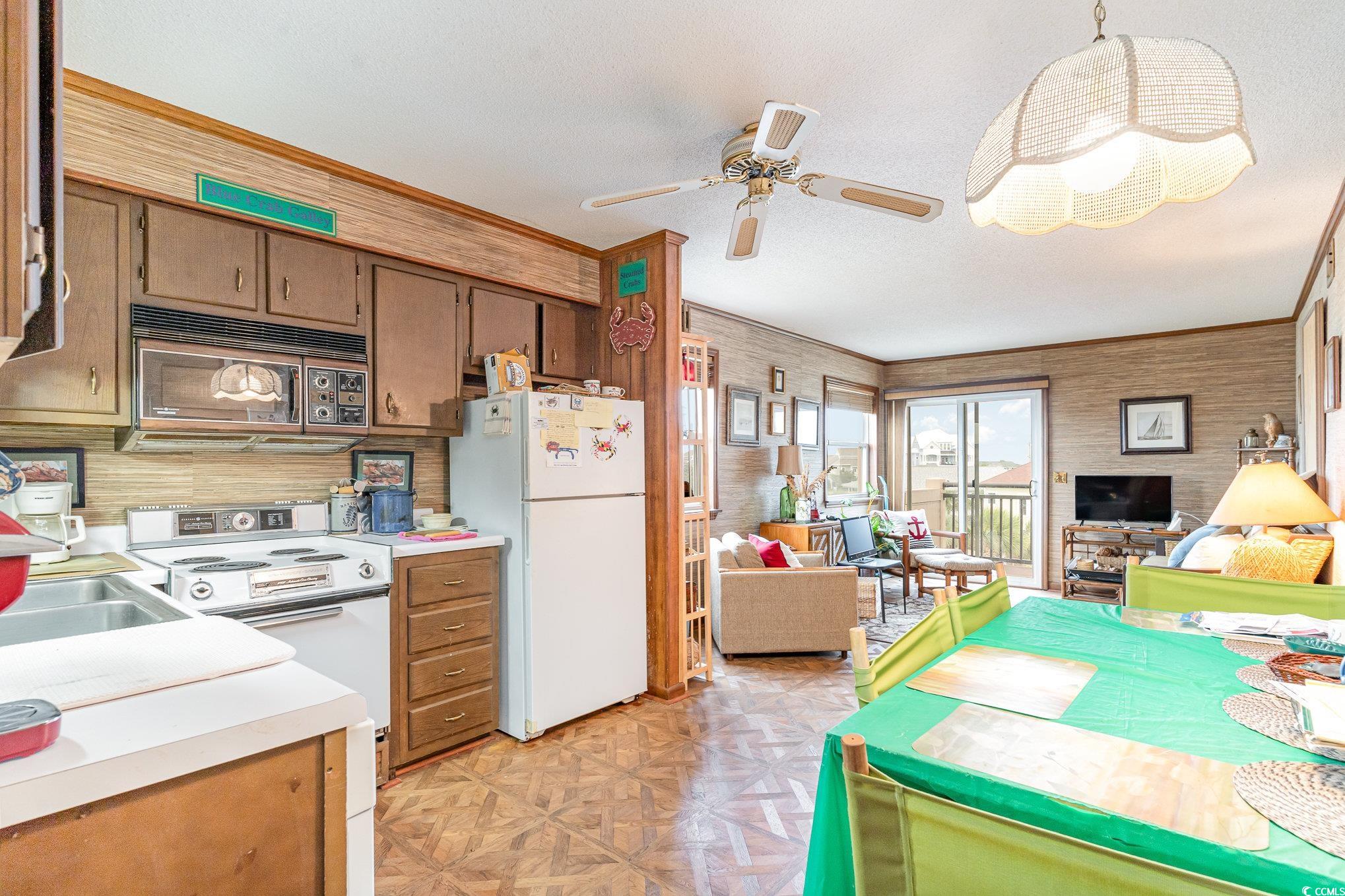 1582 South Waccamaw Drive, Unit 60 Murrells Inlet, SC 29576 - Photo 4 of 24 Kitchen featuring ceiling fan, sink, white appliances, light parquet flooring, and decorative light fixtures