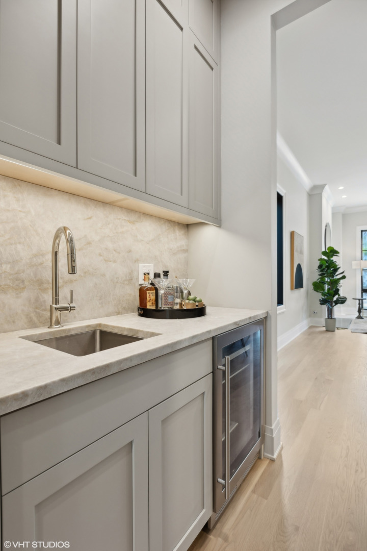 1850 West Cuyler Avenue Chicago, IL 60613 - Photo 9 of 58 a kitchen with stainless steel appliances granite countertop white cabinets a sink and dishwasher