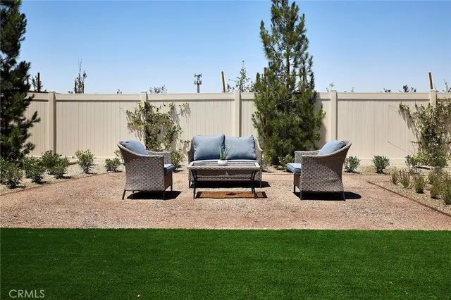 a view of a terrace with chairs and potted plants