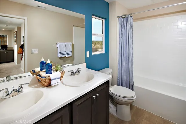 a bathroom with a sink mirror and toilet
