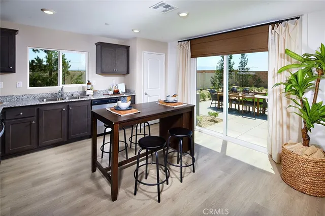 a kitchen with granite countertop a table and chairs in it