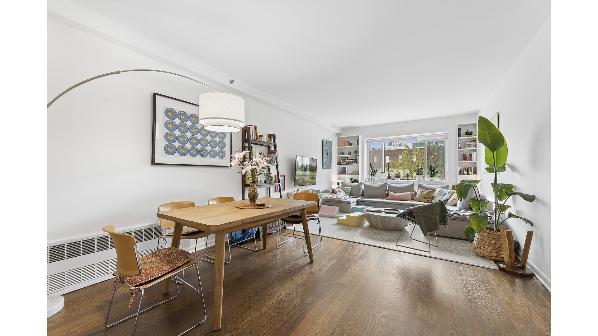 a living room with furniture a window and a table