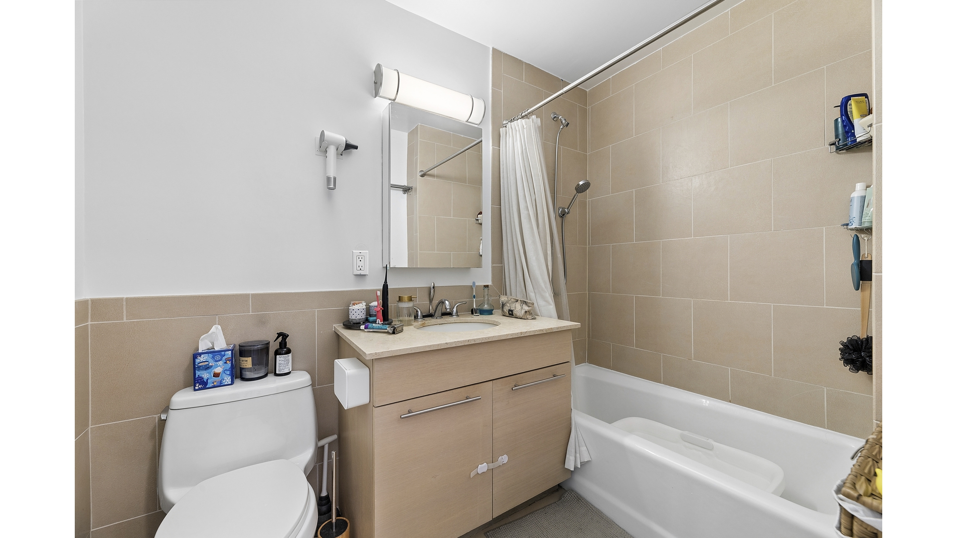 2279 3rd Avenue, Unit 3A Manhattan, NY 10035 - Photo 11 of 14 a bathroom with a sink a toilet and a bathtub