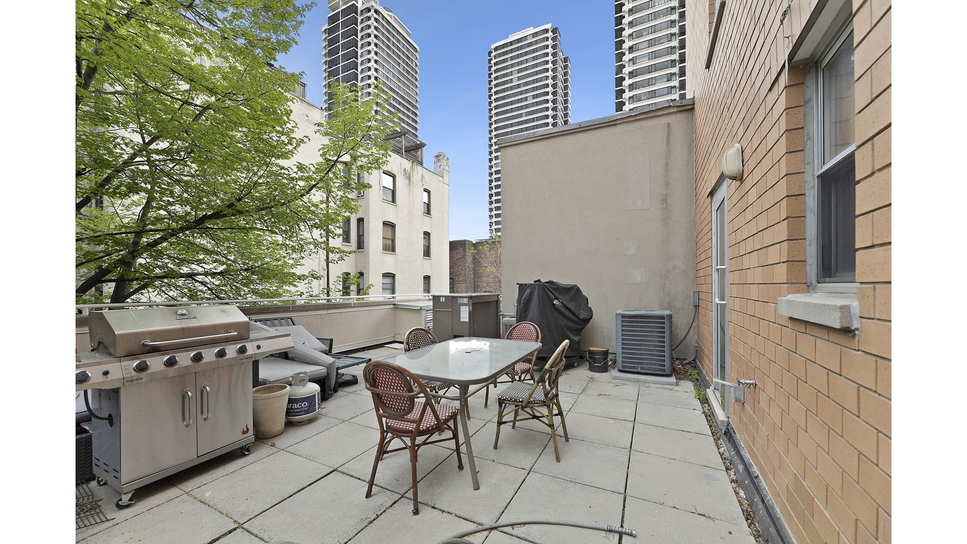 2279 3rd Avenue, Unit 3A Manhattan, NY 10035 - Photo 14 of 14 a backyard of a house with table and chairs