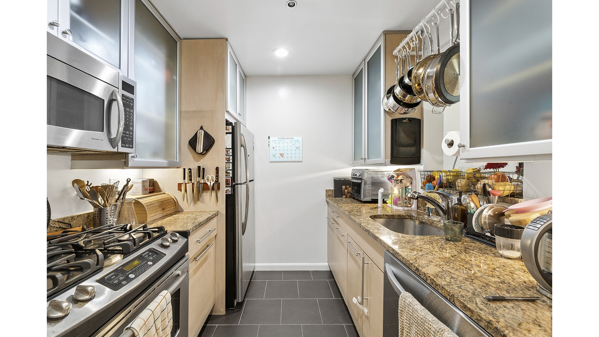 2279 3rd Avenue, Unit 3A Manhattan, NY 10035 - Photo 8 of 14 a kitchen with stainless steel appliances granite countertop a stove and a sink