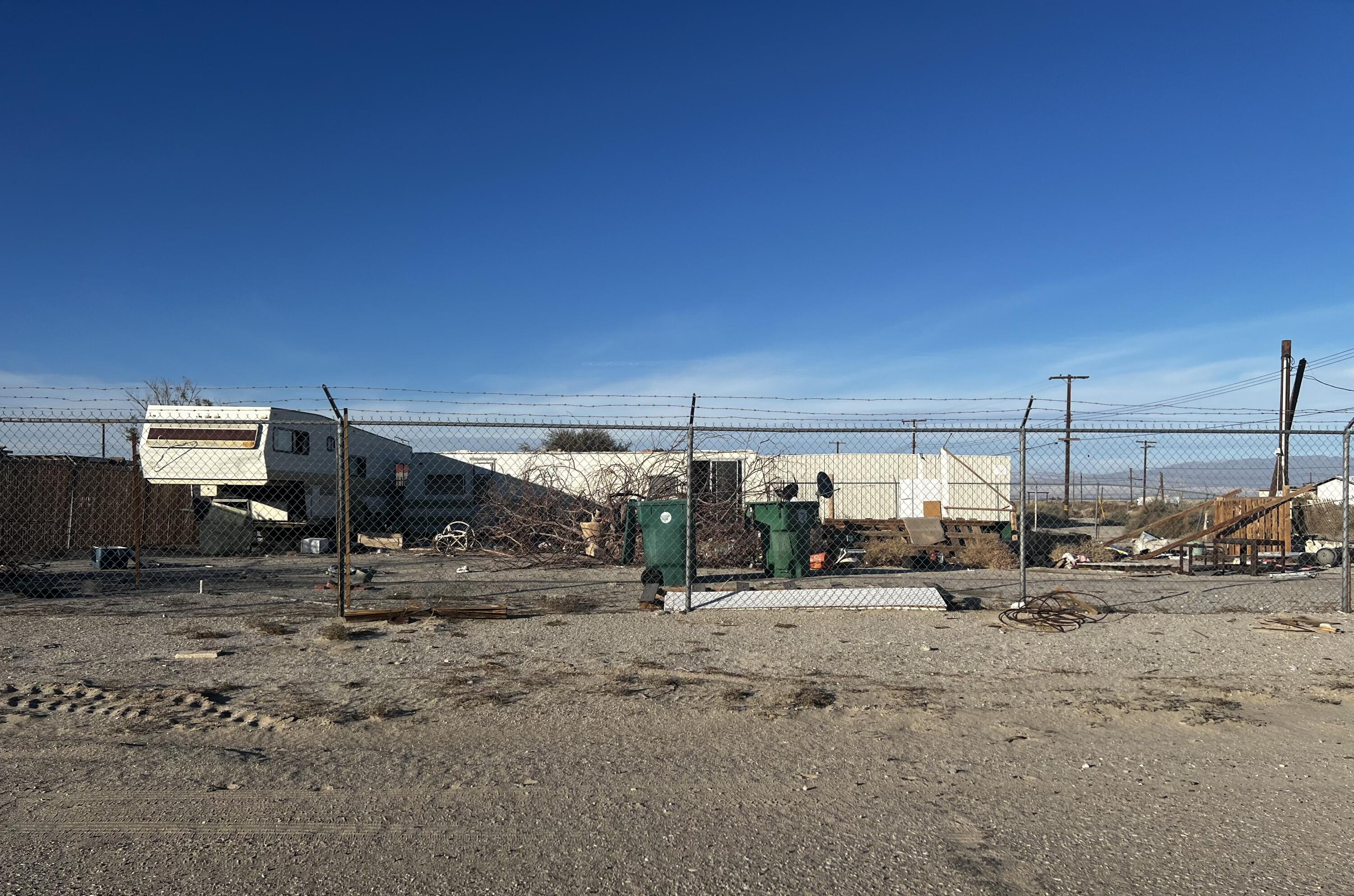 3352 Cal Avenue Salton Sea Beach, CA 92274 - Photo 4 of 9 a view of a dirt road with a parked car