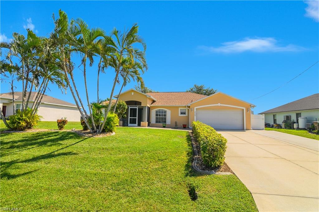 2905 Northeast 1st Place Cape Coral, FL 33909 - Photo 1 of 32 a front view of a house with a yard