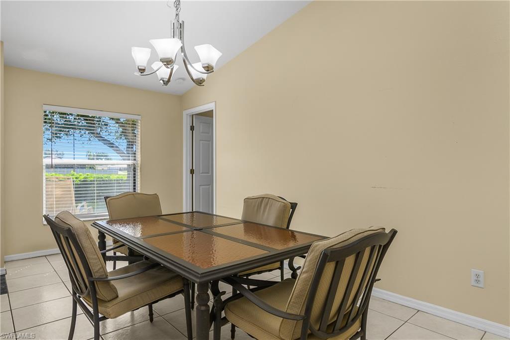 2905 Northeast 1st Place Cape Coral, FL 33909 - Photo 13 of 32 a view of a dining room with furniture and wooden floor
