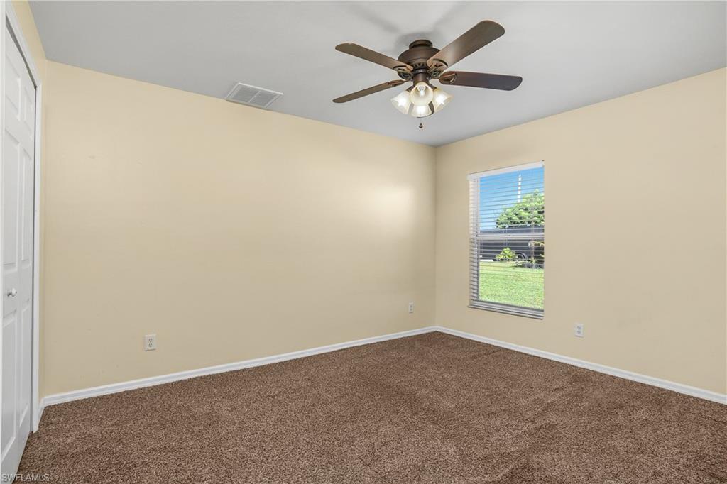 2905 Northeast 1st Place Cape Coral, FL 33909 - Photo 17 of 32 an empty room with a window and a fan