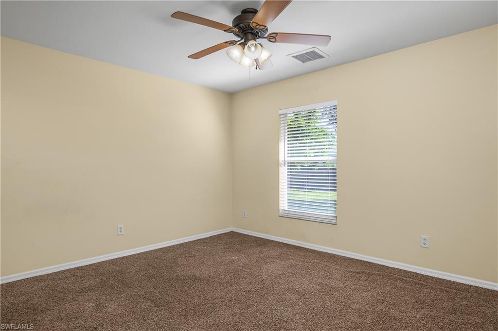 2905 Northeast 1st Place Cape Coral, FL 33909 - Photo 19 of 32 en empty room with windows and ceiling fan