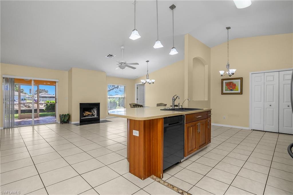 2905 Northeast 1st Place Cape Coral, FL 33909 - Photo 32 of 32 a large kitchen with stainless steel appliances granite countertop a stove and a view of living room
