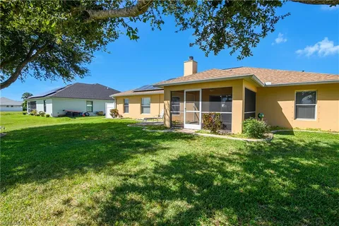 a view of a room with wooden floor and a yard