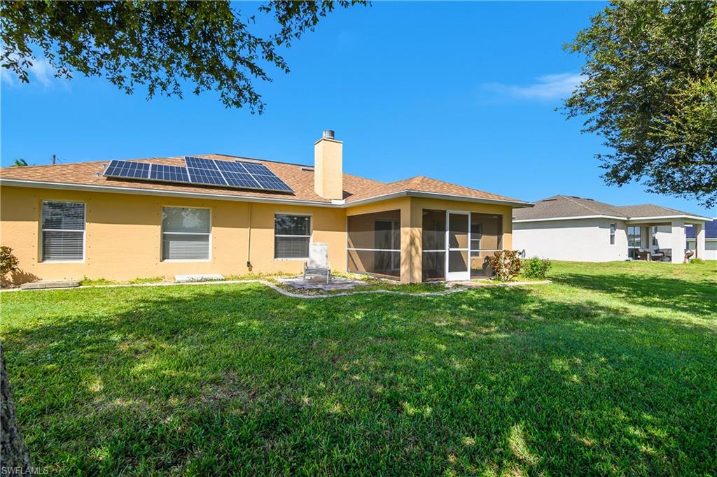 2905 Northeast 1st Place Cape Coral, FL 33909 - Photo 28 of 32 a view of a house with a backyard